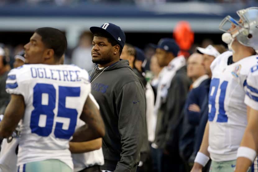 Dallas Cowboys suspended player Josh Brent watches action on the sideline against the...