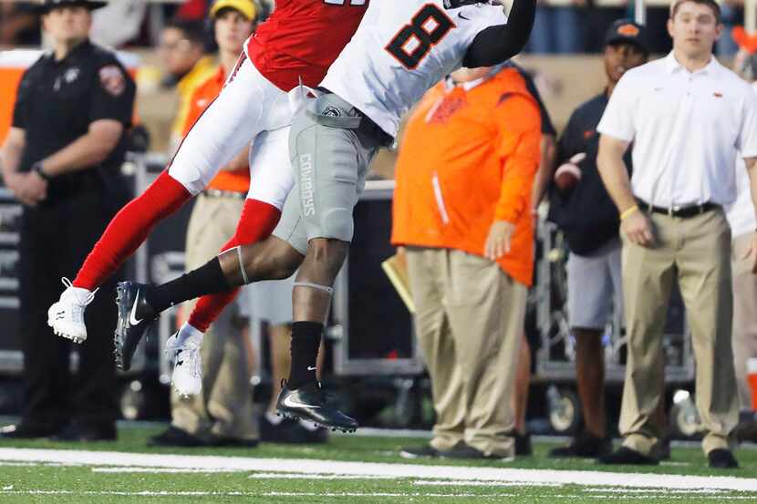 Texas Tech wide receiver Derrick Willies can't haul in this first quarter pass defended by...
