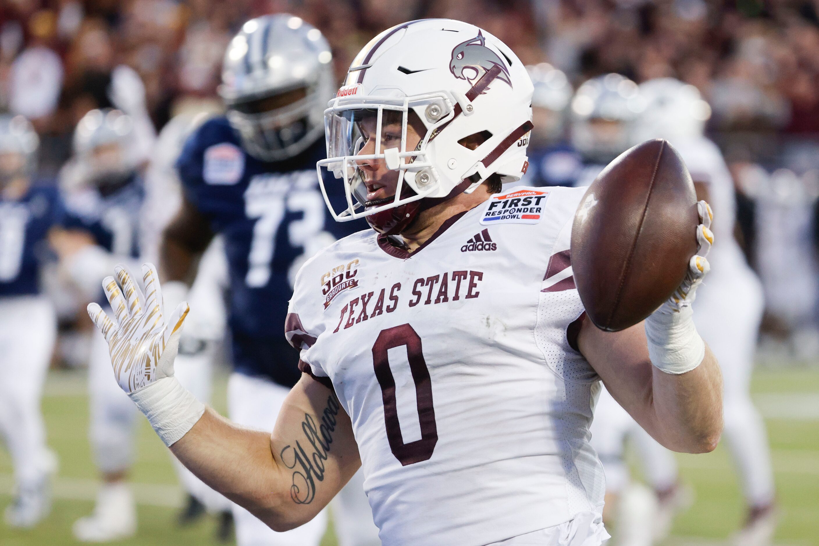 Texas State linebacker Brian Holloway (0) celebrates a pick-six during the first half of a...