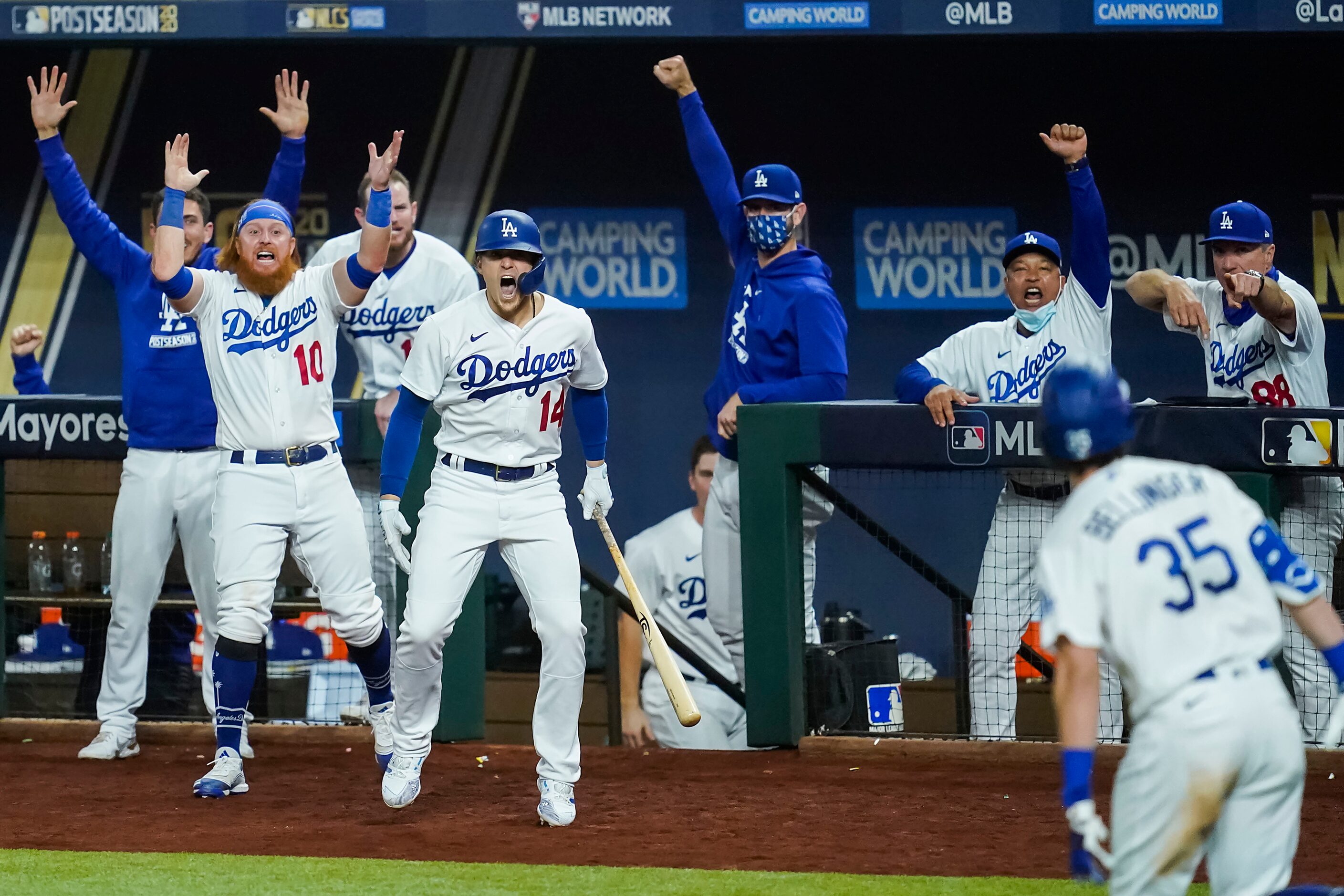 The Los Angeles Dodgers dugout erupts after center fielder Cody Bellinger (35) connected on...