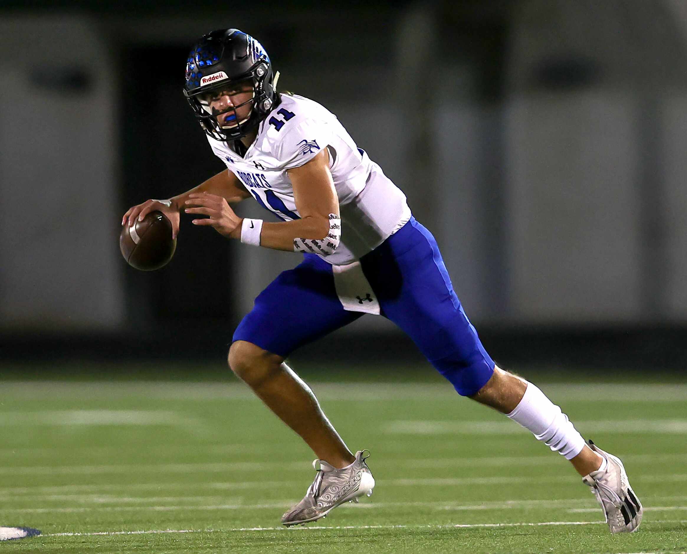 Byron Nelson quarterback Jacob Wilson rolls out of the pocket against Keller during the...
