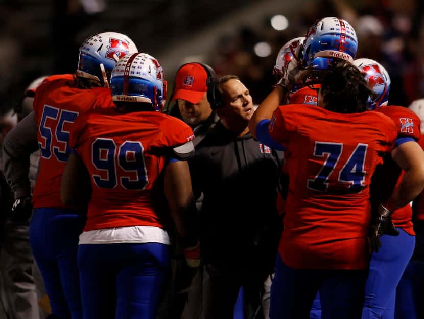 Midlothian Heritage head coach Lee Wiginton shares some wisdom with his players during a...