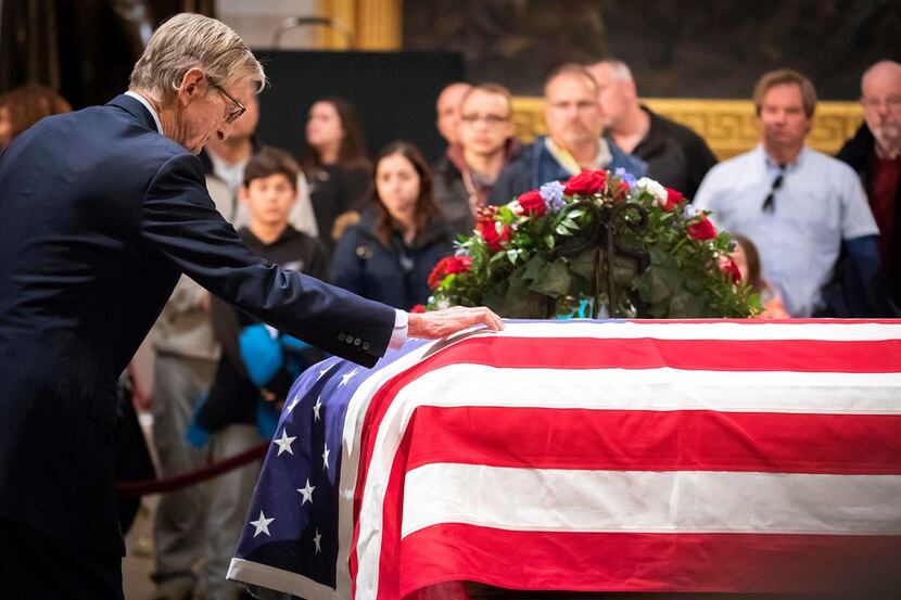 Jonathan J. Bush, the brother of the former President, visits the flag-draped casket of...