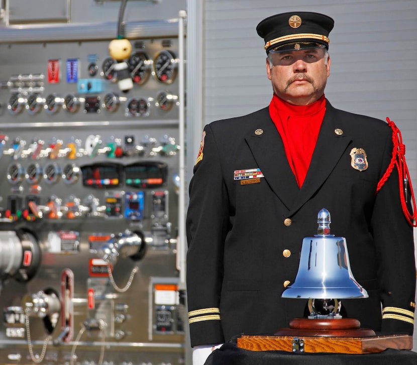 
Wylie Fire Department Capt. Matt McCormick stands solemnly after ringing the bell in...