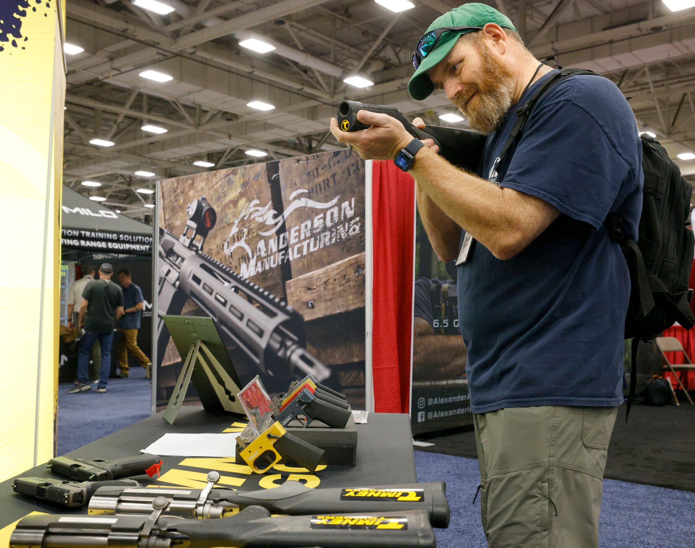 Richard Boughton of Dallas holds a  product at the Timney Triggers booth, during 2024 NRA...