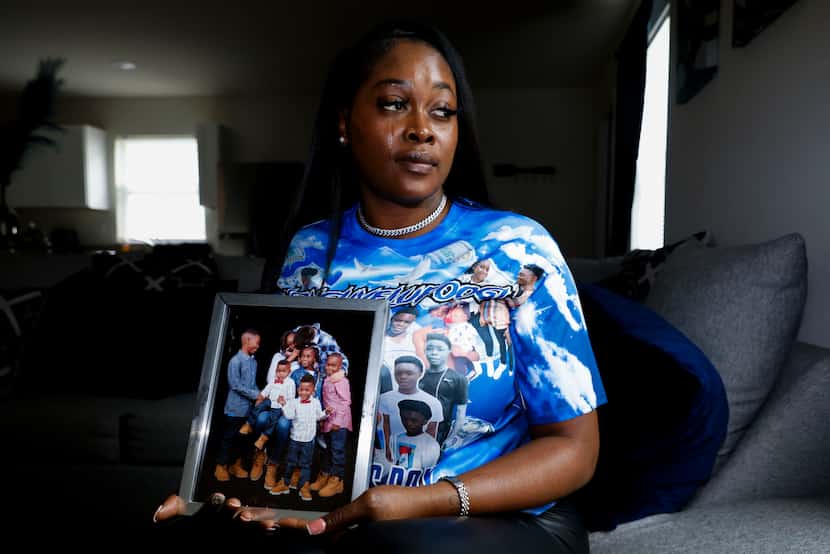 Yadira Campbell poses for a photo holding a family photo, which includes her 16-year-old...