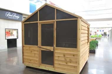 Inside Butscher Construction's cabin are upholstered bunks and a sofa. The playhouse can fit...