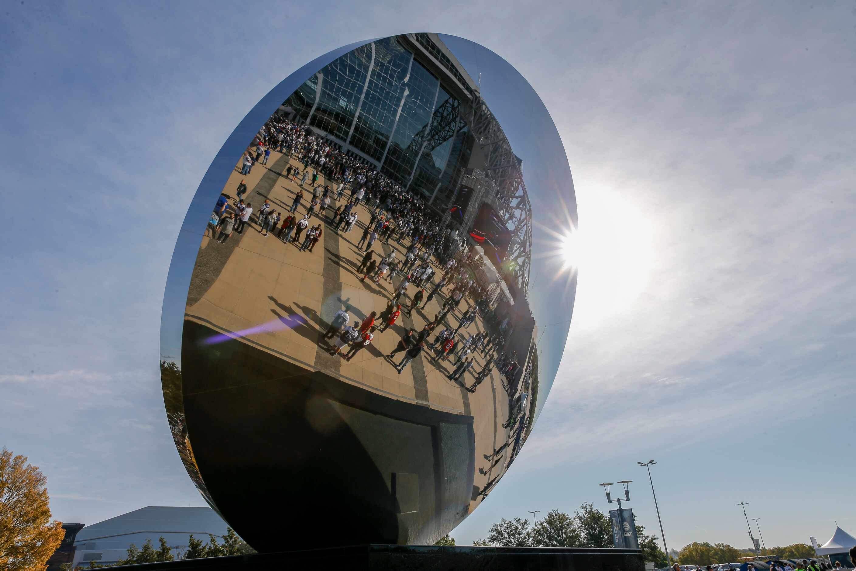 Fans are reflected in “Sky Mirror” before an NFL football game between the Dallas Cowboys...
