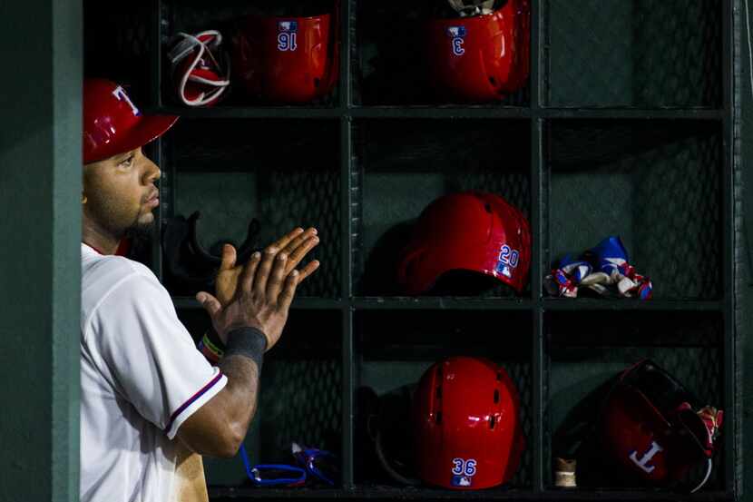 Texas Rangers shortstop Elvis Andrus (1) watches from the dugout during the third inning of...