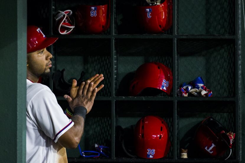 Texas Rangers shortstop Elvis Andrus (1) watches from the dugout during the third inning of...