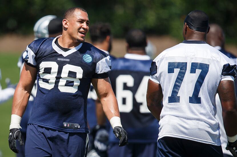 Dallas Cowboys defensive end Tyrone Crawford (98) laughs with offensive tackle Tyron Smith...