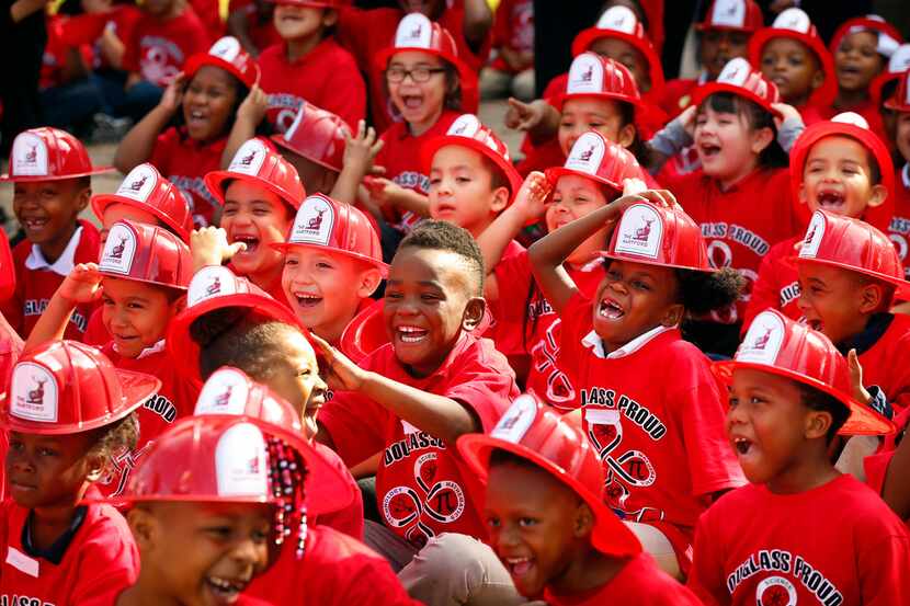 Kids at Frederick Douglass Elementary School in Dallas laugh at the Texas Rangers mascot...