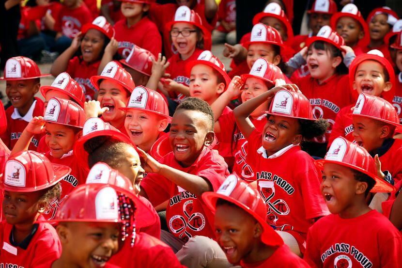 Kids at Frederick Douglass Elementary School in Dallas laugh at the Texas Rangers mascot...