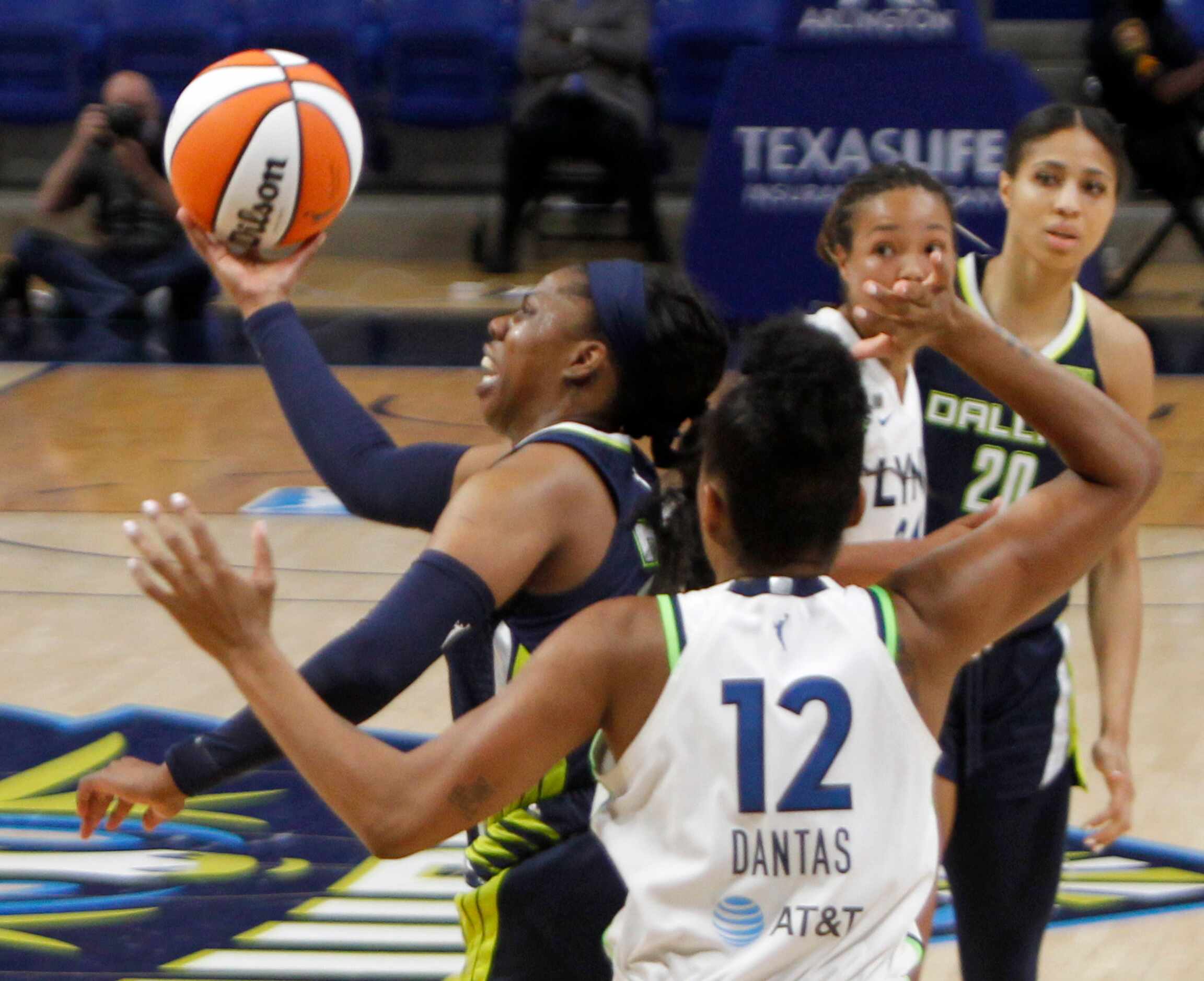 Dallas Wings guard Arike Ogunbowale (24) drives the lane after cutting inside the defense of...