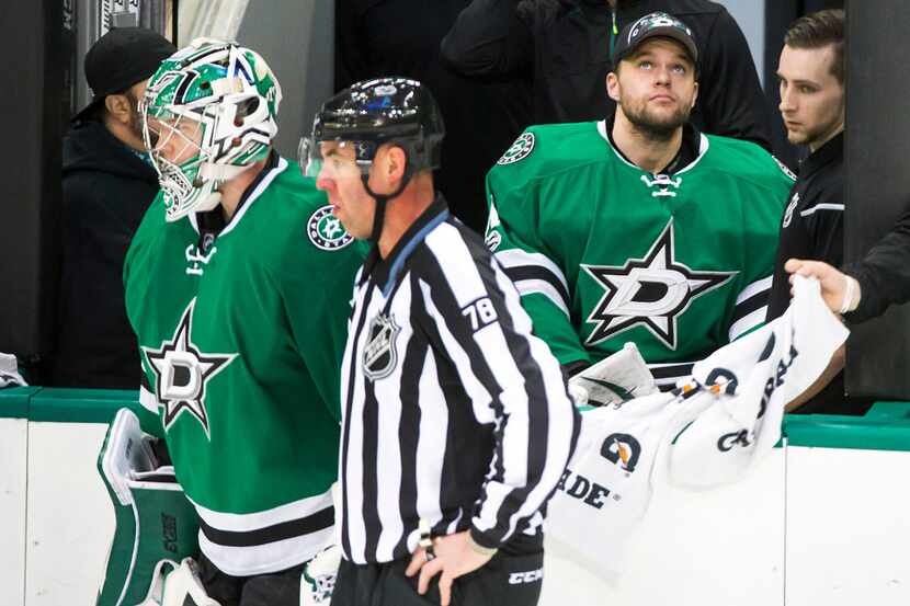 Dallas Stars goalie Antti Niemi (right) watches from the bench as fellow goalie Kari...