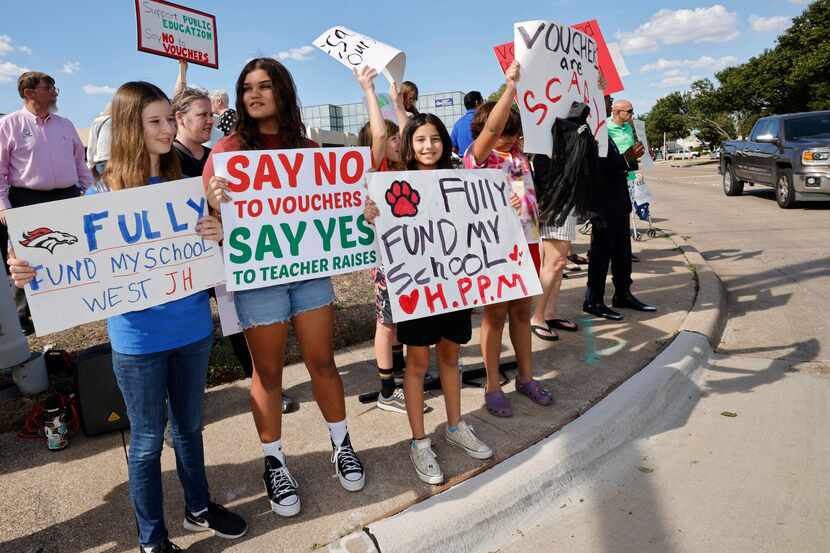 People including Shadia Jaber, 14, left,  and Maya Howery, 13,  second from left, both from...