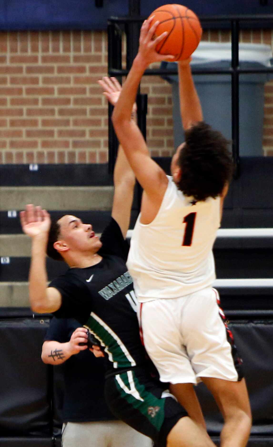 Coppell guard Anthony Black (1) puts up a shot as he is defended by Waxahachie guard Jalen...