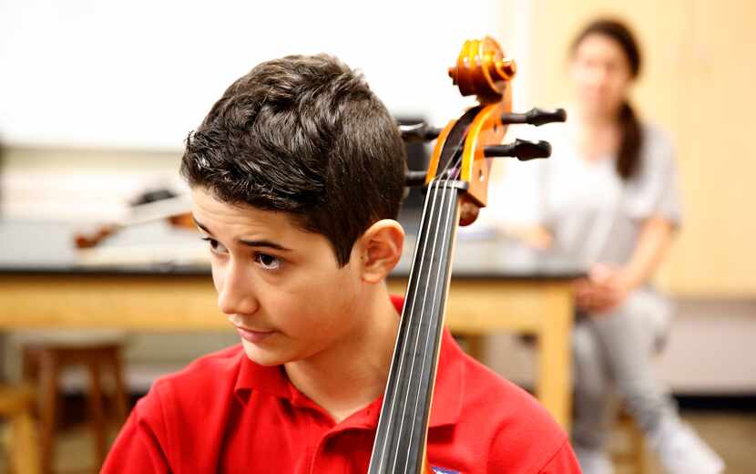 Zach Thibodeaux listens to his instructor Julia Gray-Lion during his second cello lesson at...