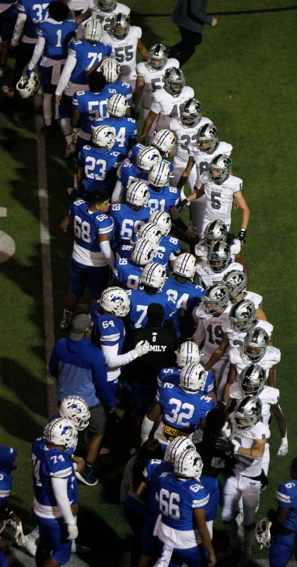 Arlington Martin players, right, shake hands with Grand Prairie players following Martin's...