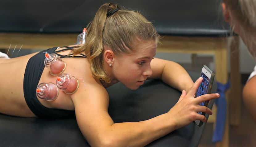 Gymnast Ragan Smith gets treated with cup therapy and acupuncture after a workout at...