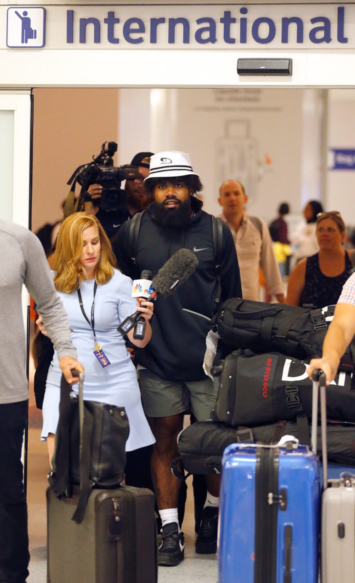 Dallas Cowboys running back Ezekiel Elliott arrives through customs at Dallas Fort Worth...