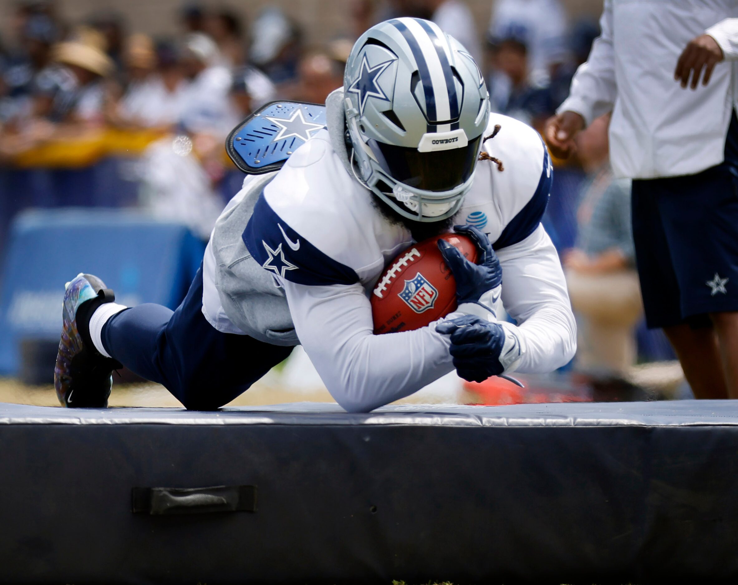 Dallas Cowboys running back Ezekiel Elliott (21) dives onto the pads after safety Tyler...