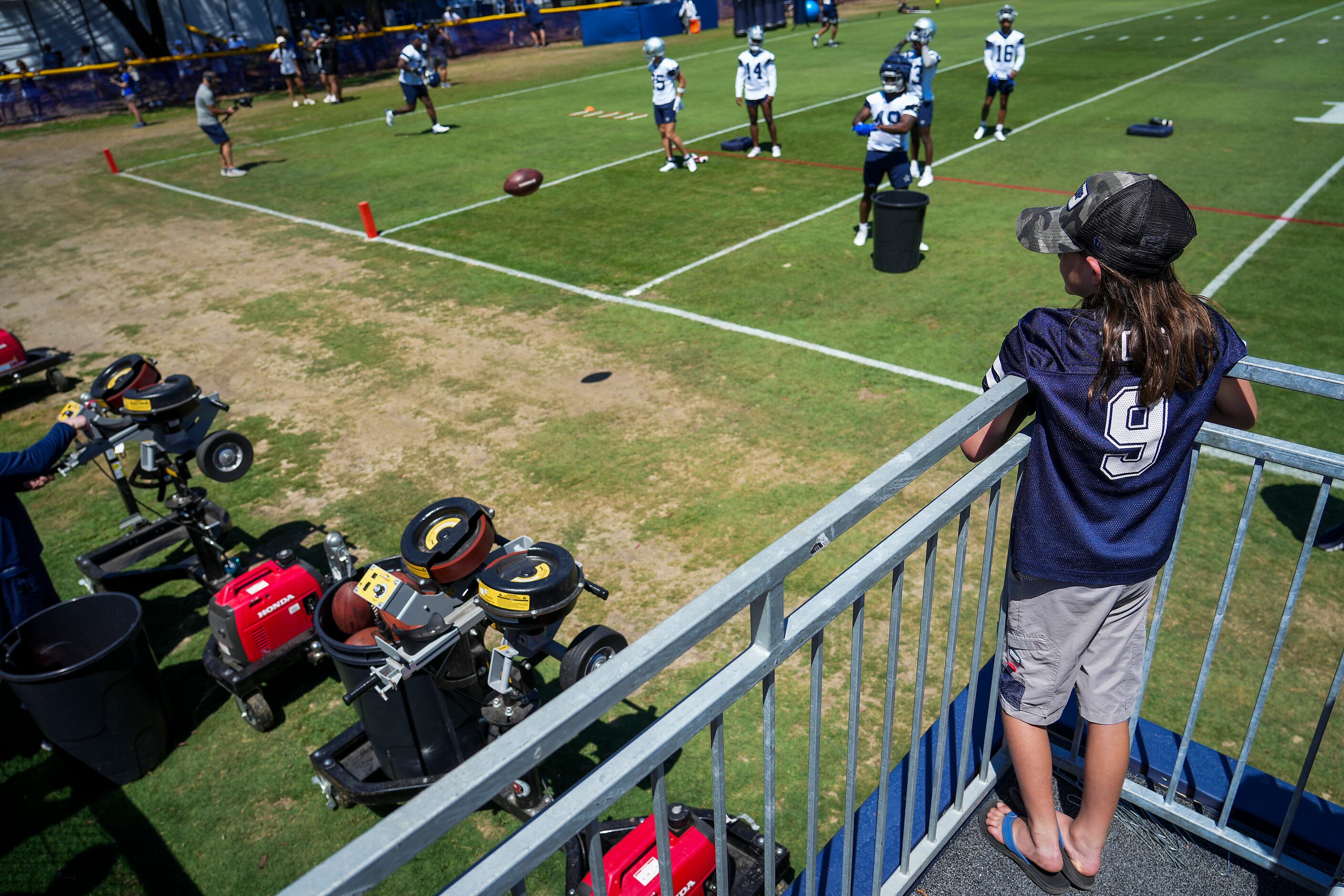 A young fan looks over a Dallas Cowboys training camp practice from a VIP viewing area on...