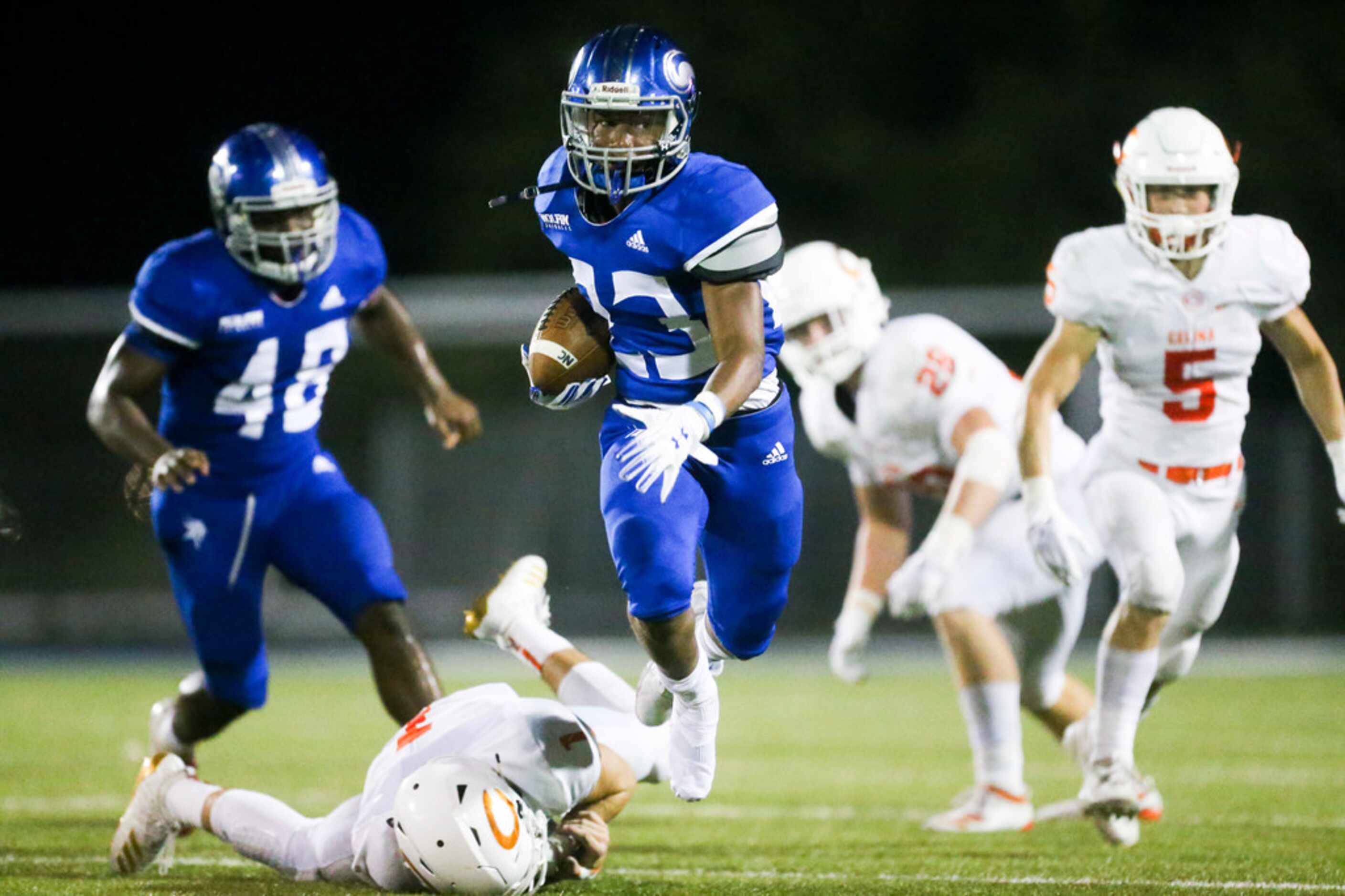Nolan Catholic running back Sergio Snider (23) carries the ball past Celina defensive back...
