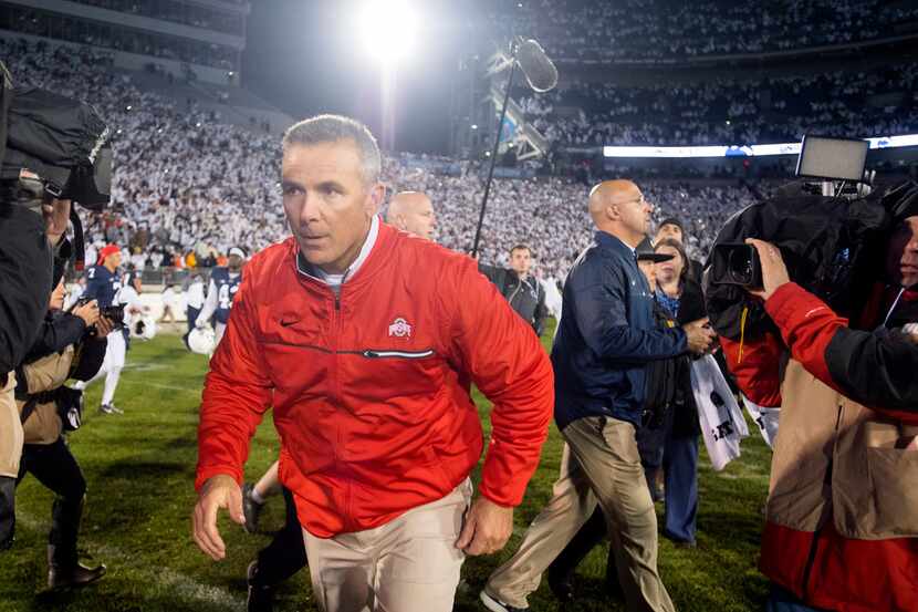 Ohio State head coach Urban Meyer runs off the field after a 24-21 loss against Penn State...