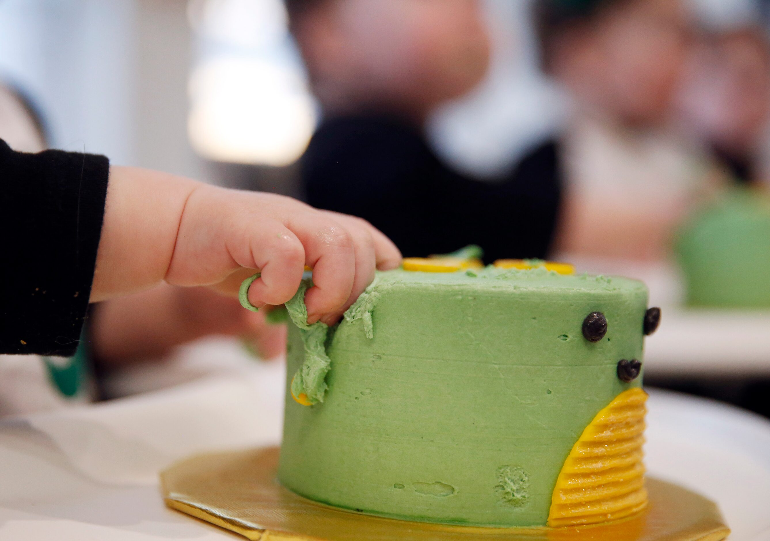 Harrison Marr digs into his cake during their one year birthday party at their home on...