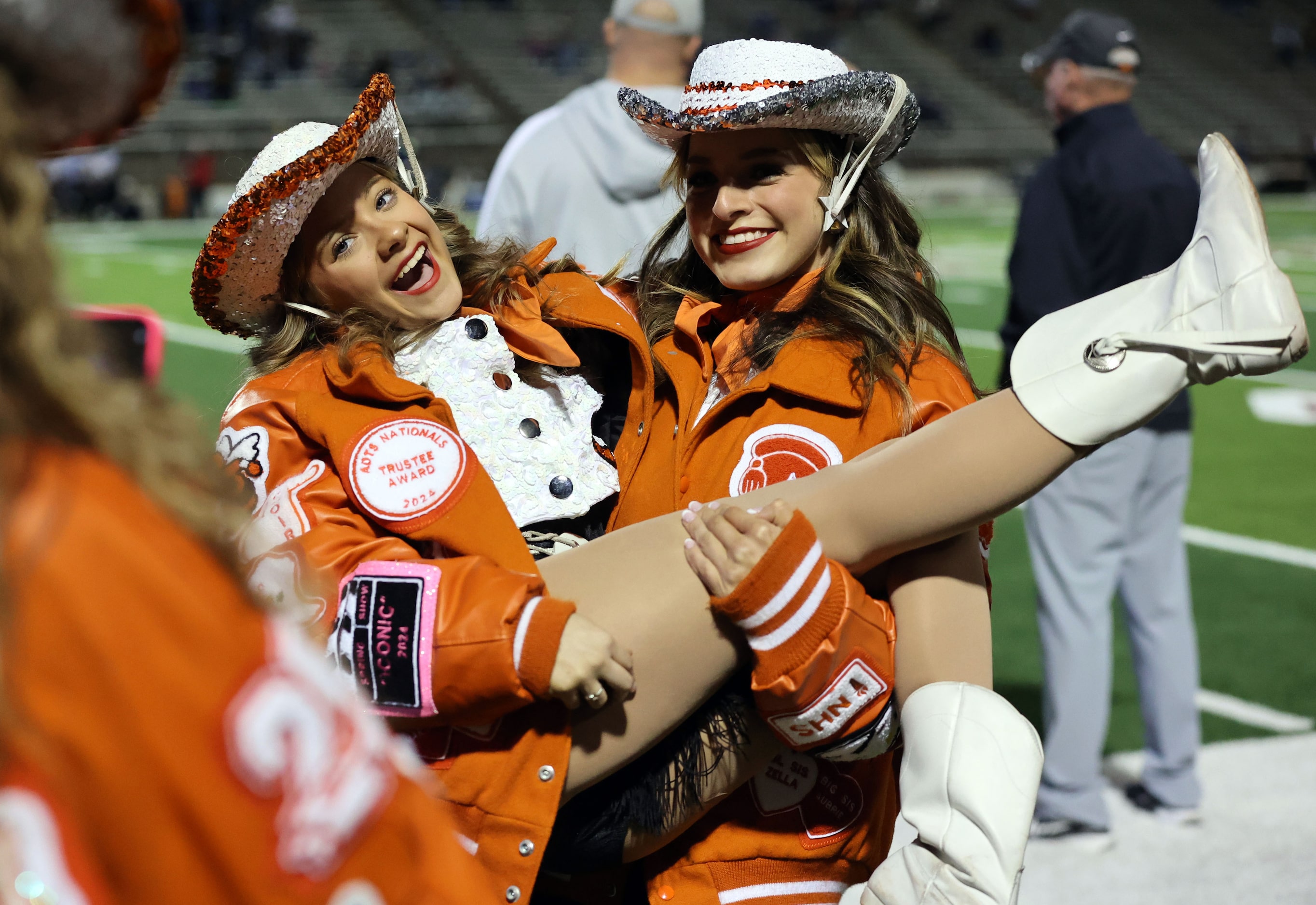 Rockwall High students pose for a photo on the sideline before the first half of a high...