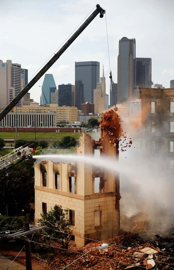 A wrecking crew demolishes the historic Ambassador Hotel after it was gutted by a four-alarm...