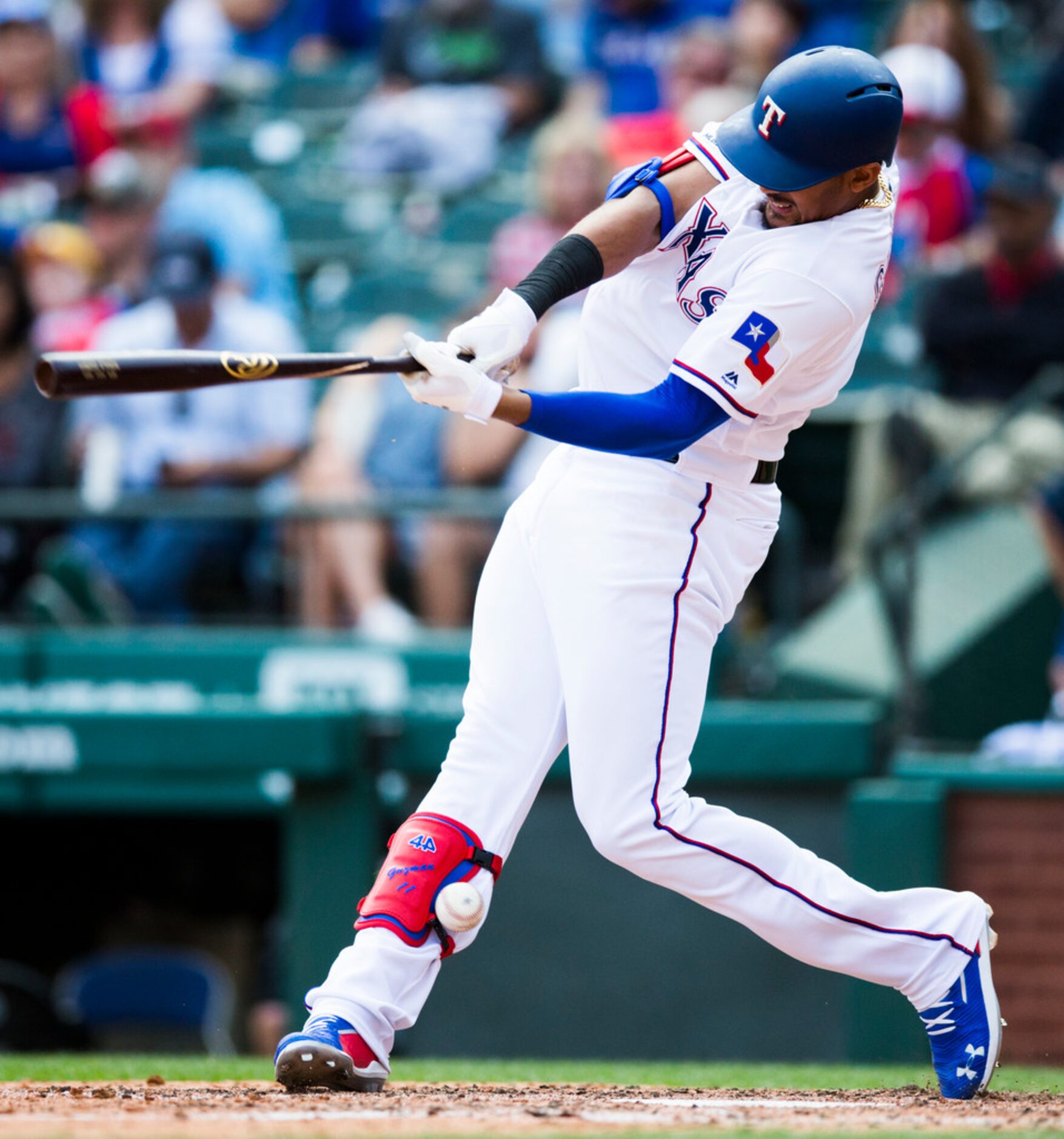 A ball hits Texas Rangers first baseman Ronald Guzman (11) after deflecting from his broken...