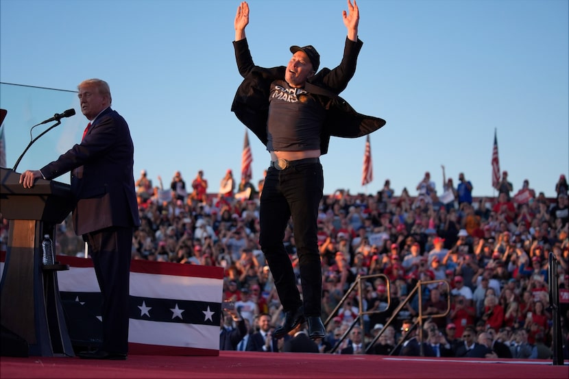 Elon Musk jumps on the stage as Republican presidential nominee former President Donald...