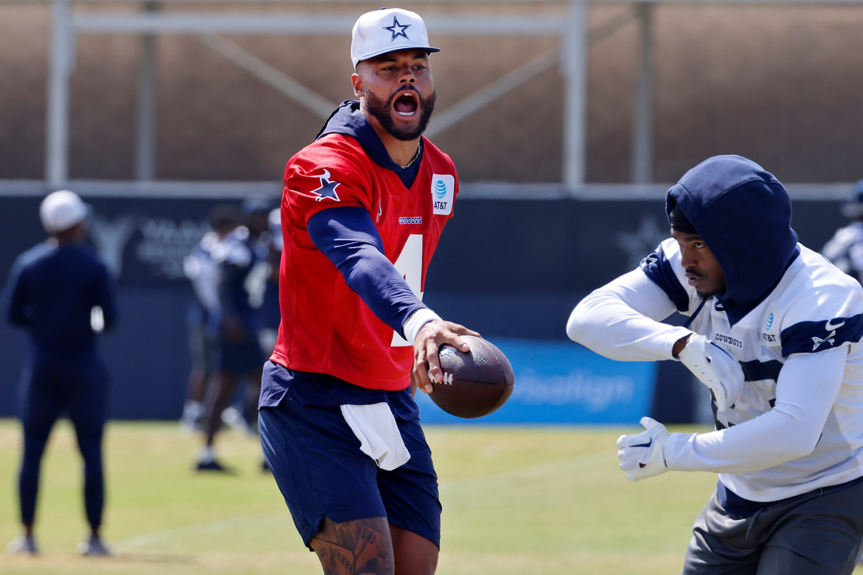 Dallas Cowboys quarterback Dak Prescott (4) barks at running back Rico Dowdle (23) during a...