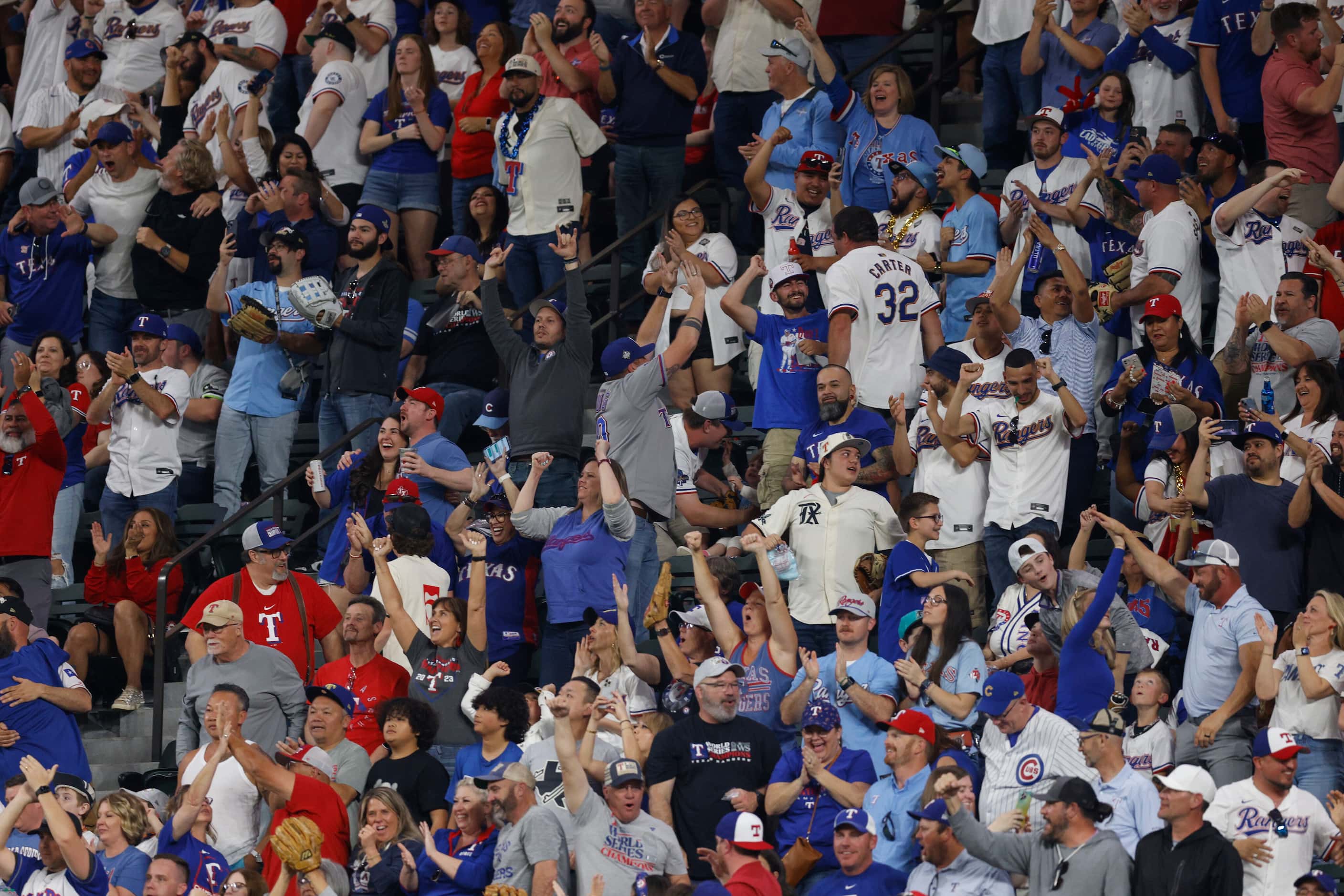 Texas Rangers fans cheer after a home run by Texas Rangers left fielder Travis Jankowski...