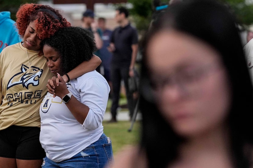 Mourners pray during a candlelight vigil for the slain students and teachers at Apalachee...