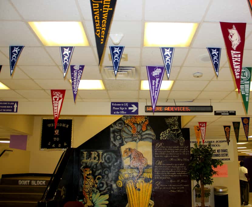 College pennants hang in the hallway at LBJ High School in Austin, Texas.