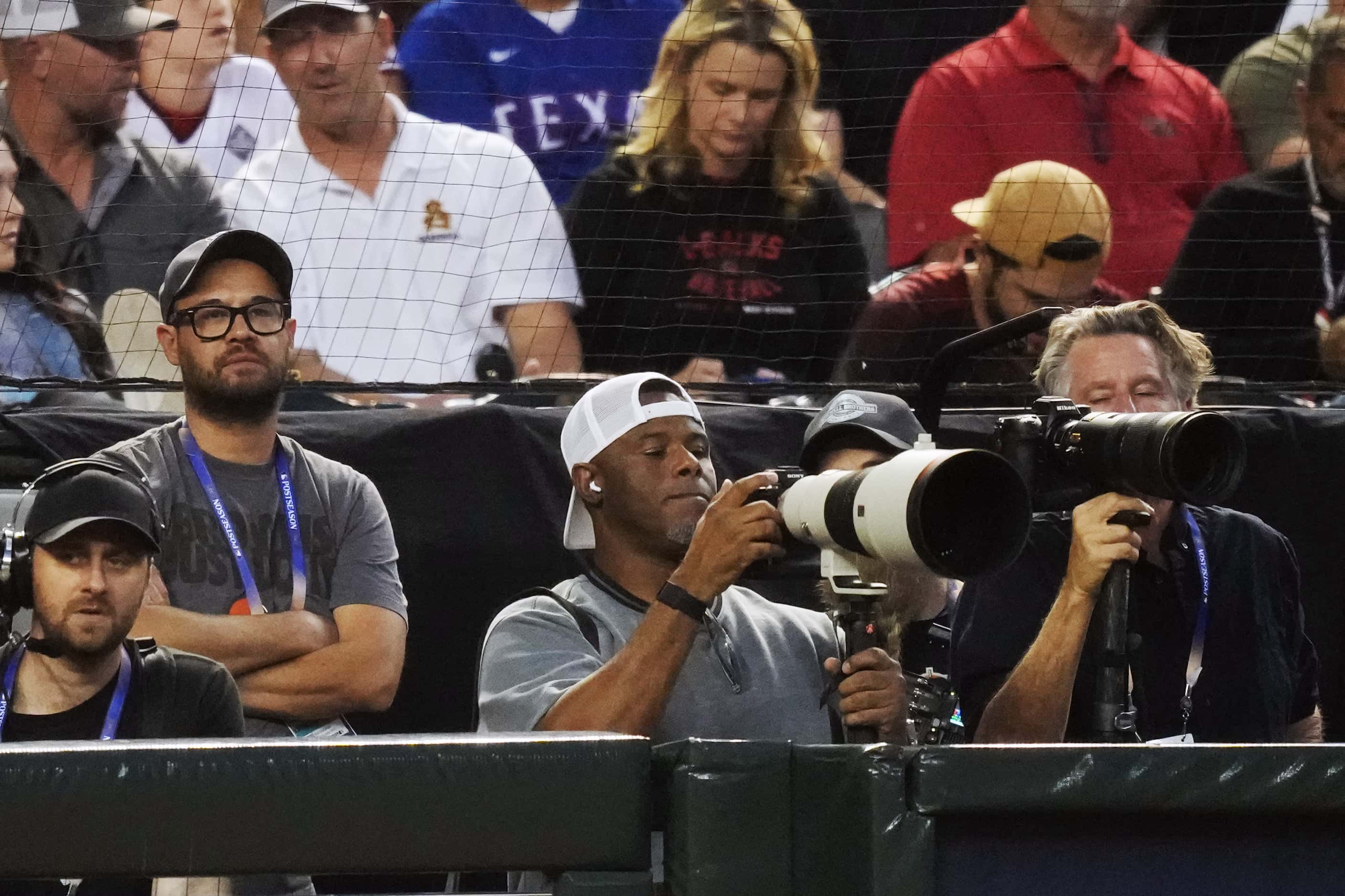 Former MLB player Ken Griffey Jr. is seen photographing Game 5 of the World Series between...