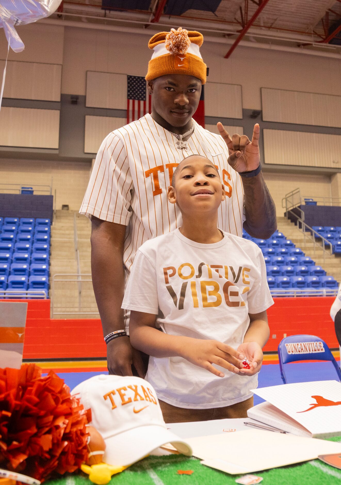 Defensive end Colin Simmons poses with his brother Clayton Roberts, 8, after signing his...