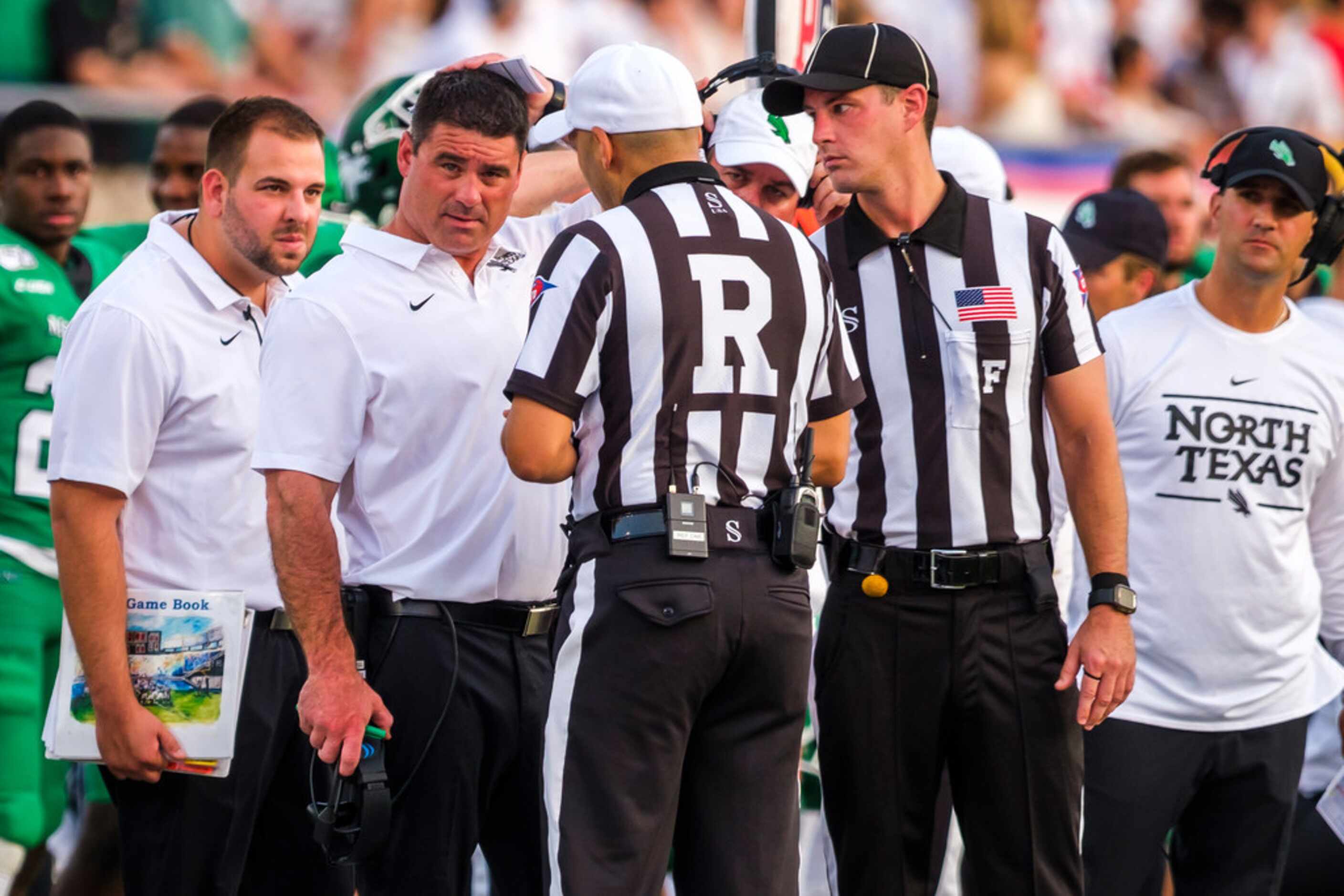 UNT head coach Seth Littrell talks to the officials during the first half of an NCAA...