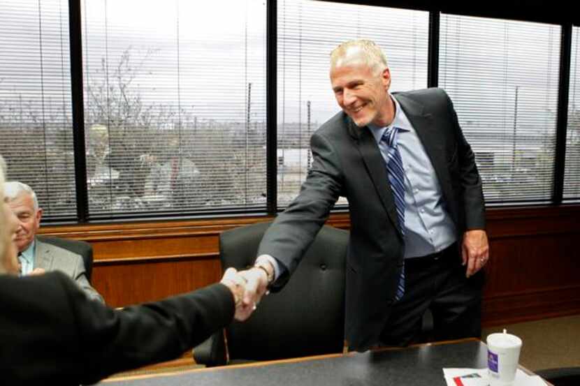 
Garland ISD superintendent Dr. Bob Morrison shakes hands with assistant superintendent...