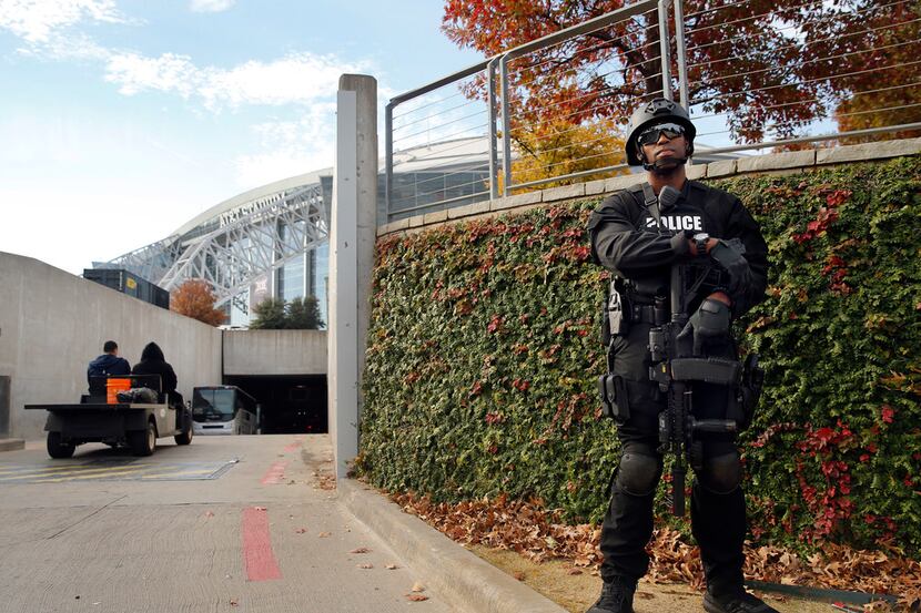 An armed Arlington SWAT officer stands guard at the AT&T Stadium tunnel entrance before the...