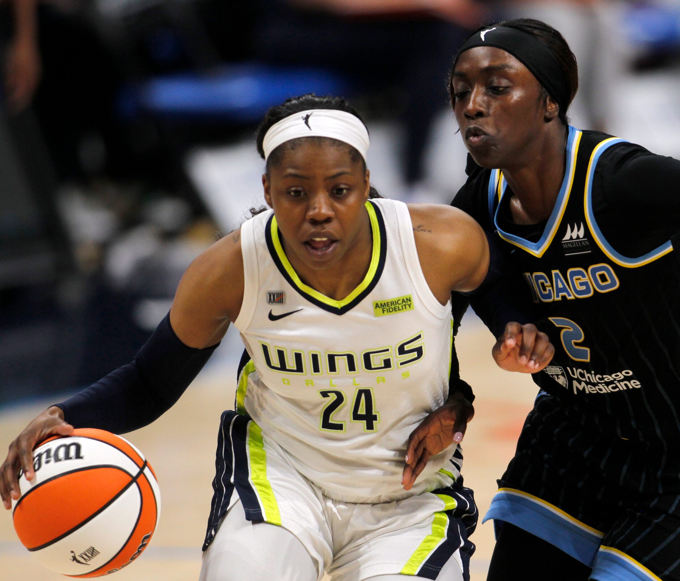 Dallas Wings guard Arike Ogunbowale (24) drives past the defense of the Chicago Sky guard...