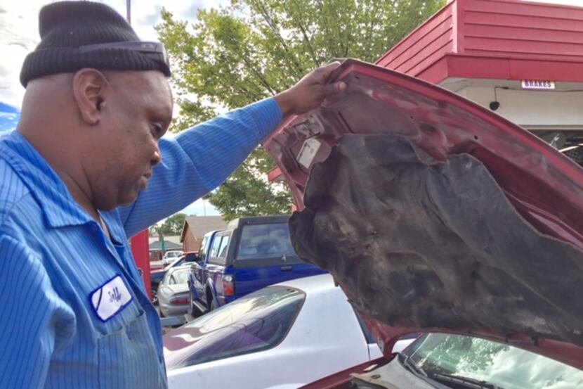 Jeff Fleming looks at Toni Brown's car, which he has kept for 19 months without repairing.