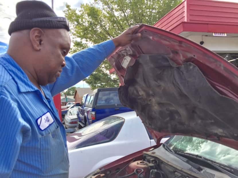 Jeff Fleming looks at Toni Brown's car, which he has kept for 19 months without repairing.