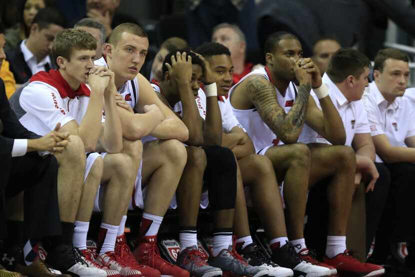 Texas Tech players watch the closing seconds of an NCAA college basketball game against TCU...