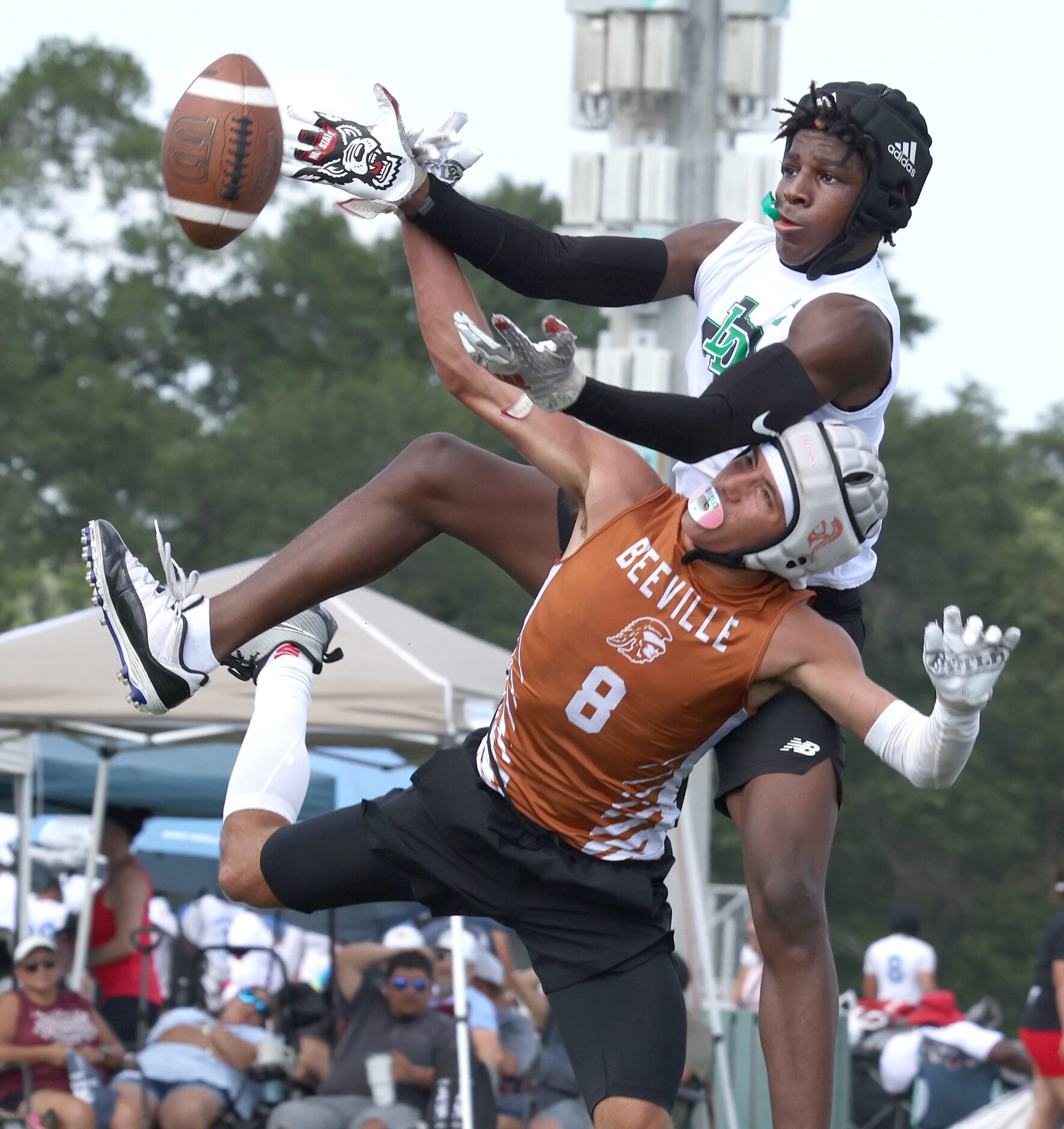 Lake Dallas defensive back Jaden Bibbs (7) leaps over a Beeville Jones receiver to break-up...