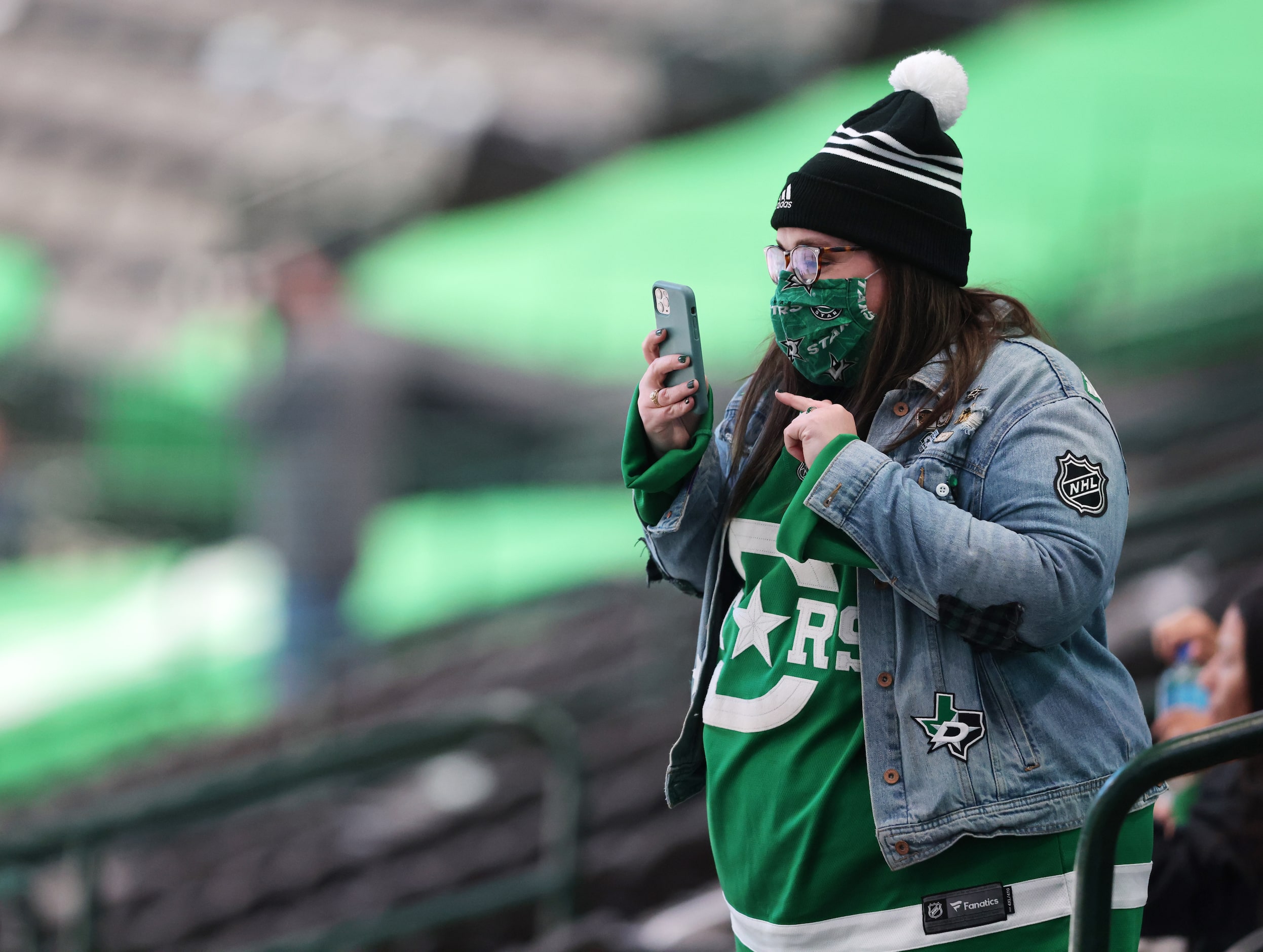 A Dallas Stars fan takes record as the Dallas Stars are introduced in a game against the...