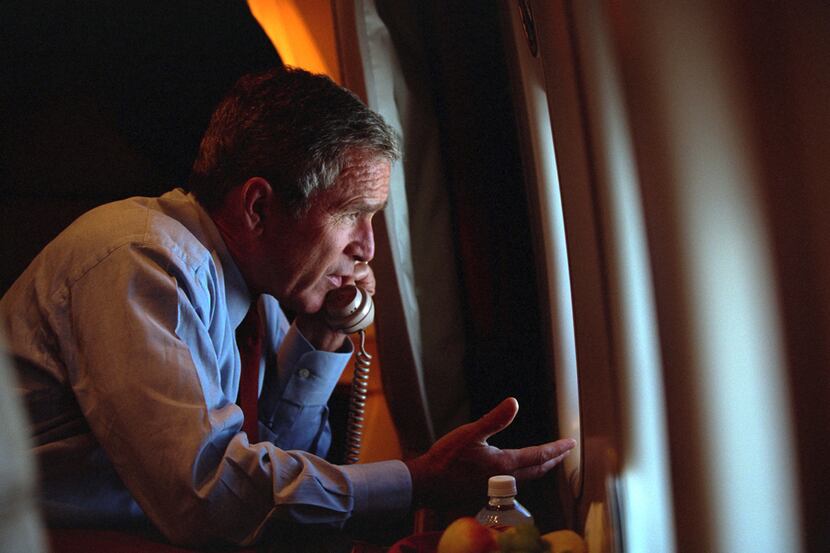 After departing Offutt Air Force Base in Nebraska, President George W. Bush confers with...